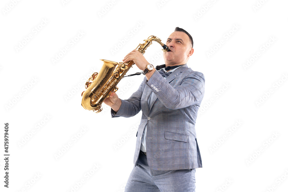 Fototapeta premium Emotional Musician male in a suit plays on saxophone isolated on white background