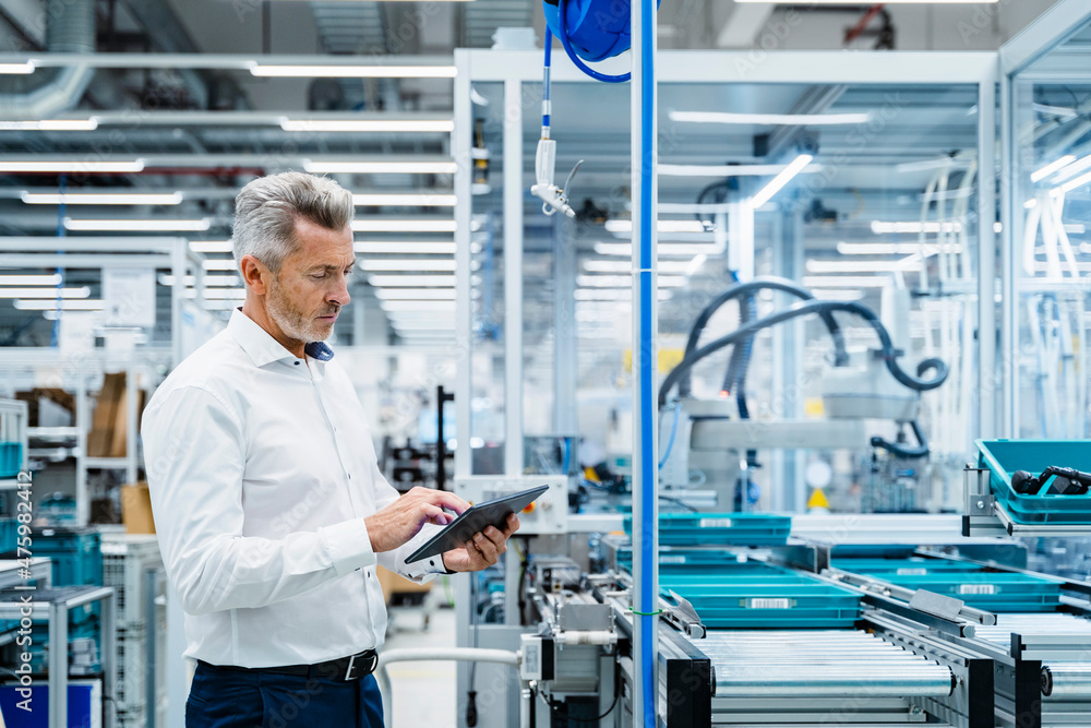 Businessman using tablet PC at automated electrical industry Businessman using tablet PC at automated electrical industry