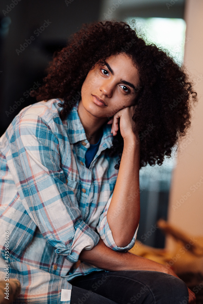 Roastery owner with curly hair sitting in store Roastery owner with curly hair sitting in store