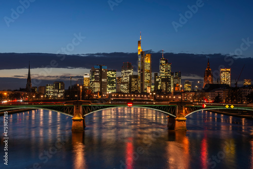 Germany, Hesse, Frankfurt, Ignatz Bubis Bridge at night with illuminated downtown skyline in background photo