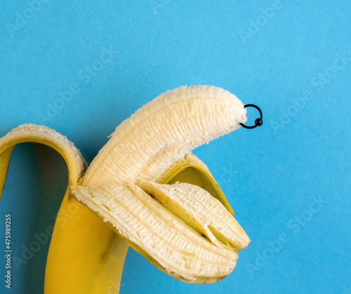 фотографія Banana with piercing decoration. Minimal piercing concept.
