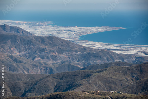 view of the greenhouses of western almeria from the mountains. You can see the villages of Balanegra, Balerma, Guardias Viejas and Almerimar surrounded by the agriculture of a sea of plastic photo