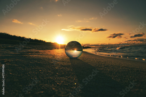 Fototapeta Naklejka Na Ścianę i Meble -  Glass globe on the beach of the Baltic Sea in Zingst in which the landscape is depicted.