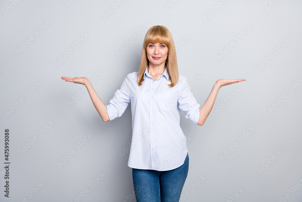 Portrait of attractive cheerful girl employer holding on palms copy space ad advert isolated over grey pastel color background Portrait of attractive cheerful girl employer holding on palms copy space ad advert isolated over grey pastel color background