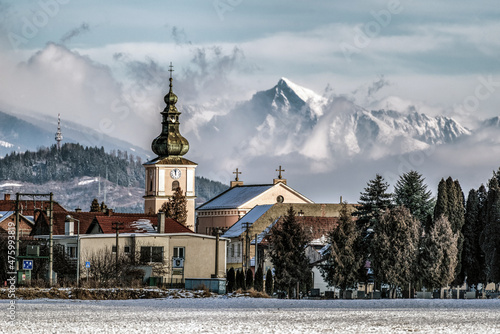 Tower of church in village Liskova, Slovakia. Peak Krivan at background photo