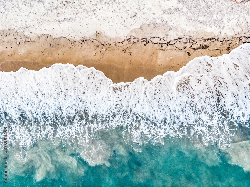 Aerial view. Sea waves and sandy beach