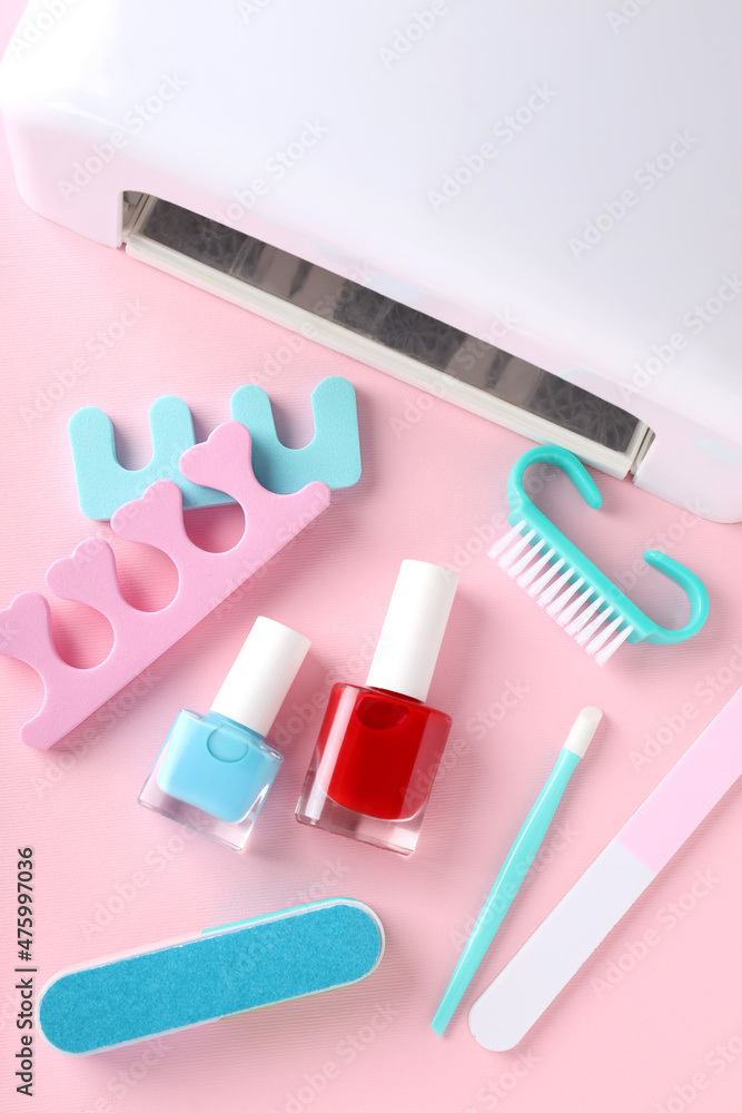 Concept of nail care with manicure accessories on pink background
