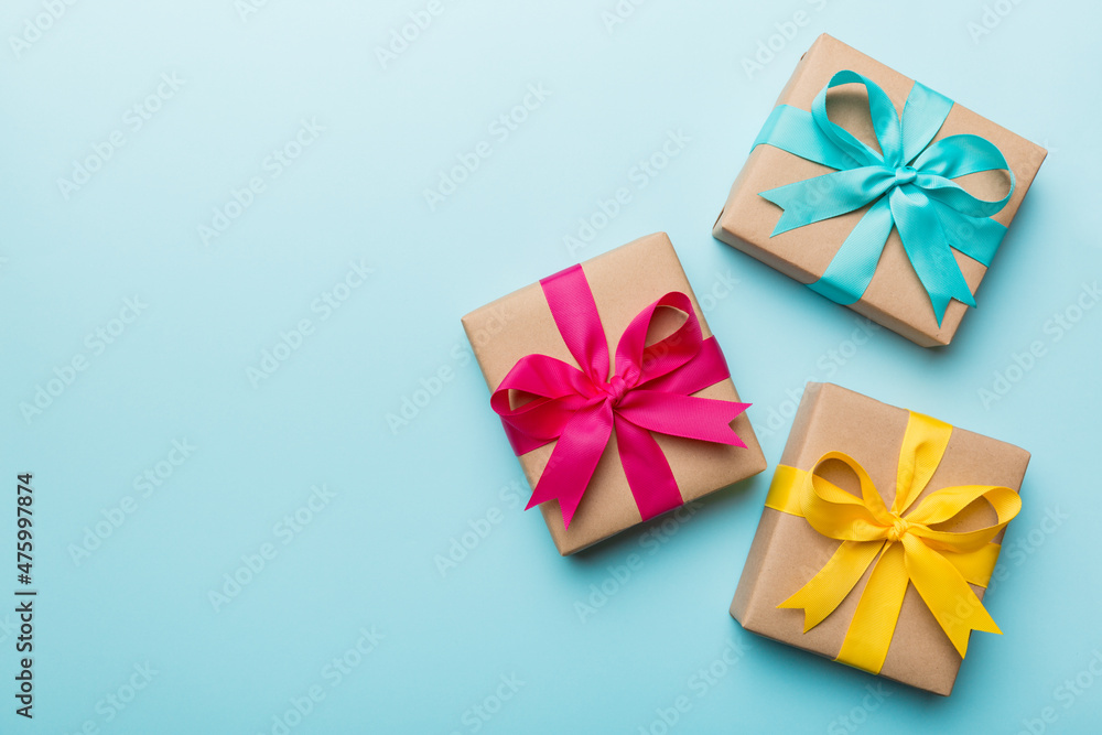 Holiday present box over colored background, top view Holiday present box over colored background, top view