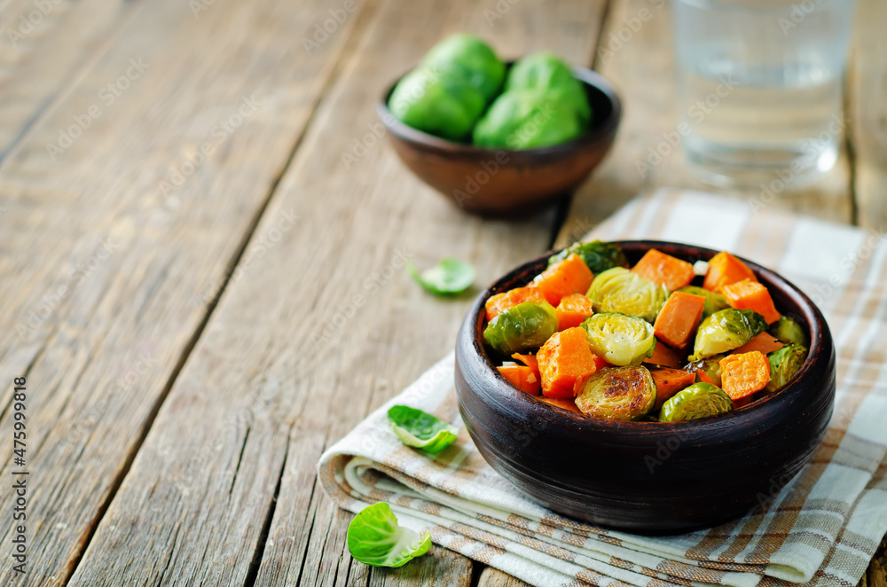Roasted Sweet potato and Brussels Sprouts on a background Roasted Sweet potato and Brussels Sprouts on a background