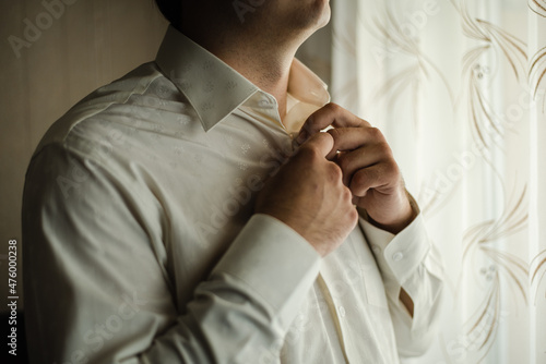A man in a white shirt. Morning of the groom. 