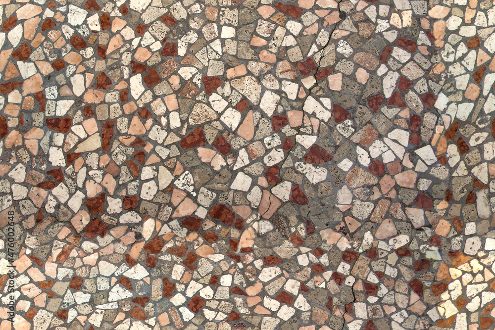 Detail of a mosaic pavement typical of Italian pedestrian streets. It's ...