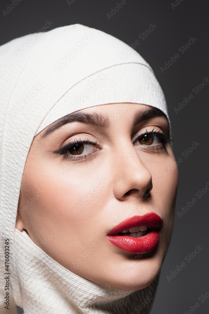 woman with in elastic bandage on head after plastic surgery isolated on grey woman with in elastic bandage on head after plastic surgery isolated on grey