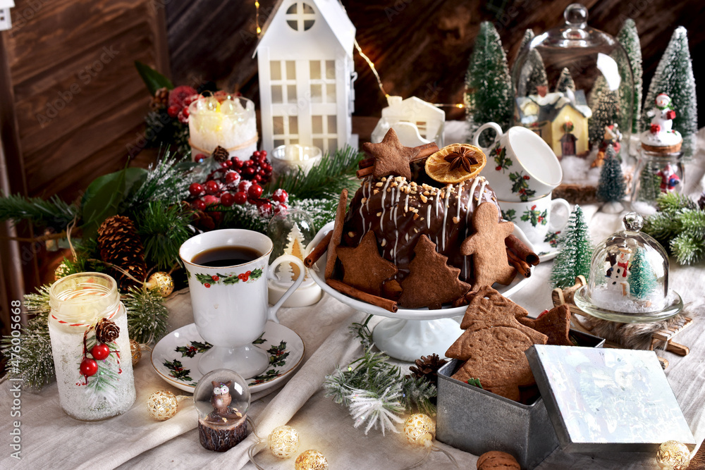 Gingerbread cookies and ring cake on festive table in vintage style for Christmas