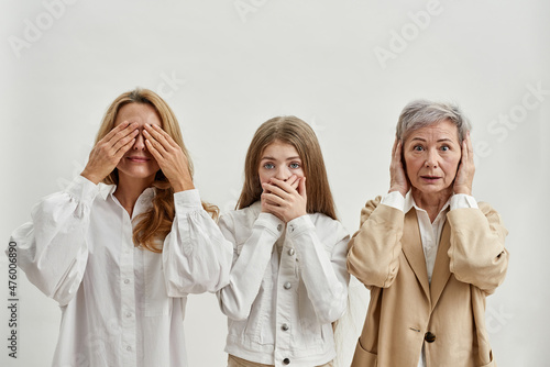 Three females show gestures of three wise monkeys photo