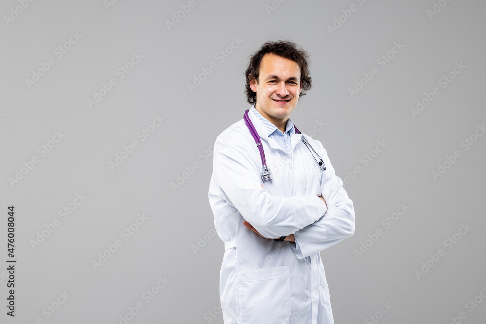 Young man doctor with crossed hands isolated on white background Young man doctor with crossed hands isolated on white background