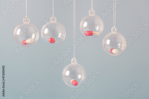 Transparent small balls with tablets capsules. Wishing health in the New Year without coronavirus.