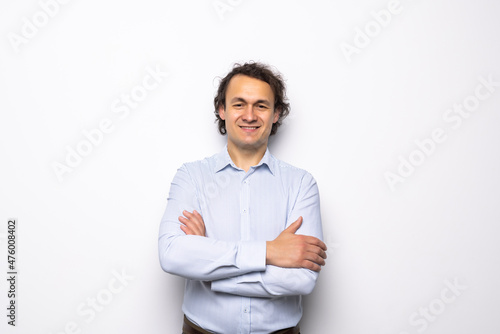Smiling businessman standing with arms folded isolated on a white background © F8  \ Suport Ukraine