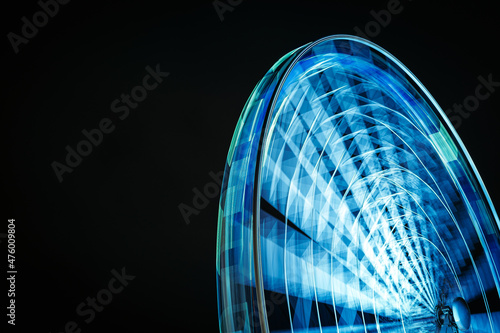 the ferris wheel on the burgplatz in düsseldorf photographed during christmas at night with a black sky and a long exposure the ferris wheel is moving