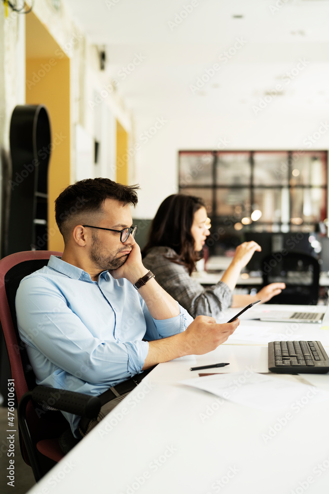 Colleagues in office. Businesswoman and businessman discussing work in office. Two friends working together Colleagues in office. Businesswoman and businessman discussing work in office. Two friends working together