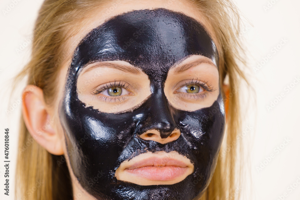 Girl black carbo peel off mask on face Girl black carbo peel off mask on face