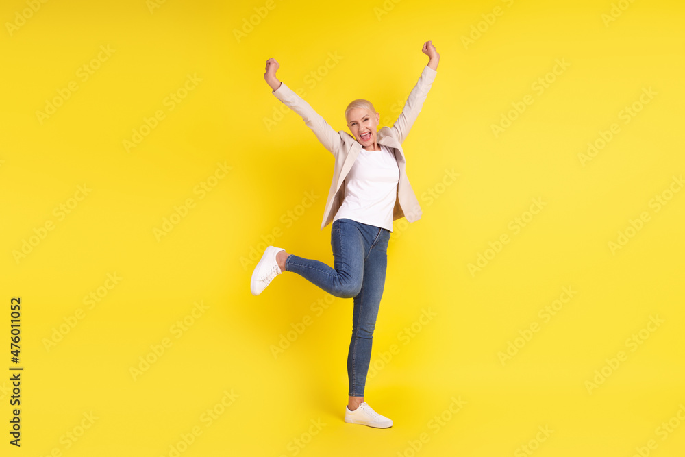 Full size photo of cheerful senior lady have fun rejoice victory discount win lottery isolated over yellow color background