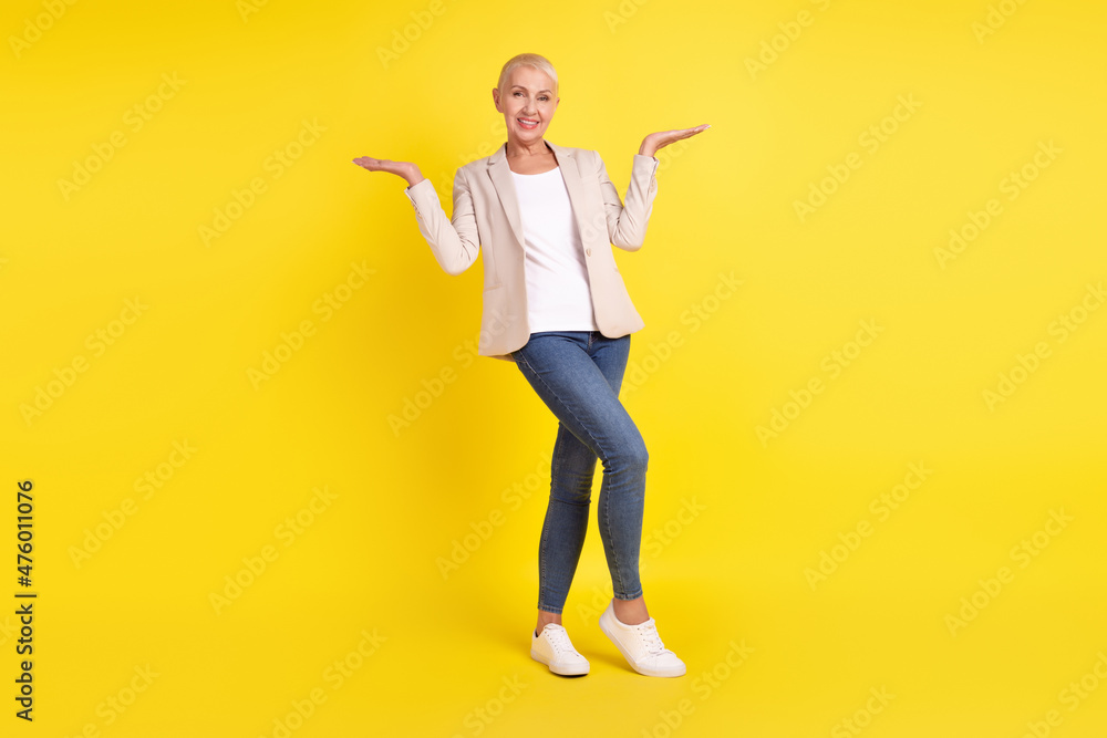 Full body photo of lovely woman promoter hold hand vs scales proposition isolated over yellow color background