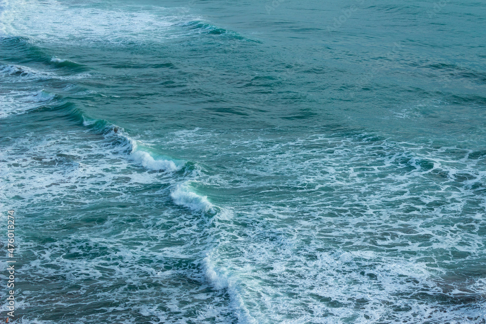 Large wave splashing in blue sea