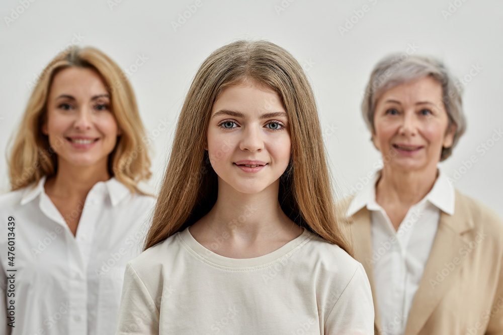 Girl before her blurred mother and grandmother Girl before her blurred mother and grandmother