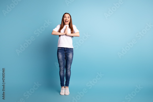 Full size photo of young cheerful woman arms together pleading gift dreamy isolated over blue color background