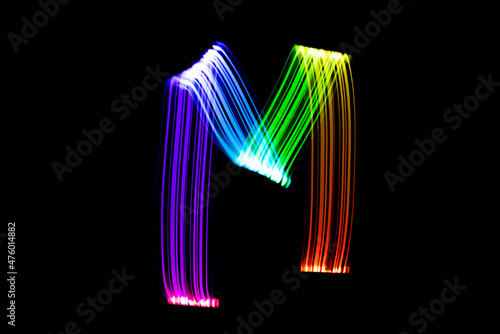 Letter M. Isolated figure on a black background. Freezelight.