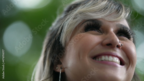 joyful girl looks up to sky with HOPE. Happy woman close-up face smiling
