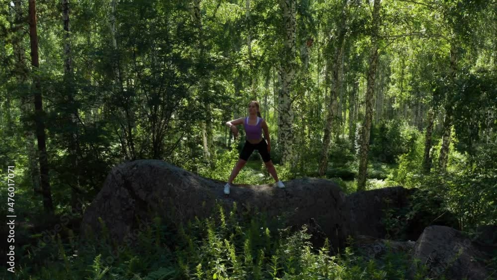 The girl is doing fitness in the forest The girl is doing fitness in the forest