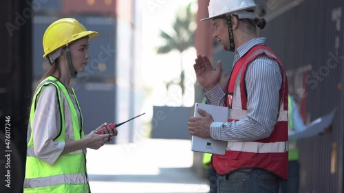 Engineer shaking hands with foreman team in hardhat and safety vest control loading containers box from cargo, Dock worker team in a shipyard, Logistic concepts.