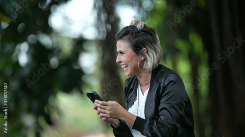 Excited happy woman celebrating good news jumping up and down receiving message