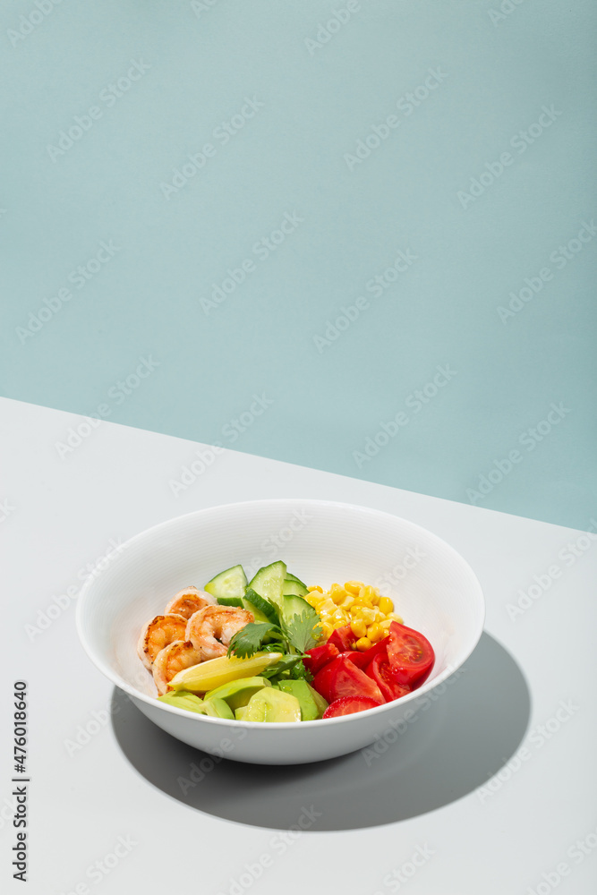 Fresh Avocado, shrimps salad with lettuce green mix, cherry tomatoes, herbs and olive oil, lemon dressing. healthy food Fresh Avocado, shrimps salad with lettuce green mix, cherry tomatoes, herbs and olive oil, lemon dressing. healthy food