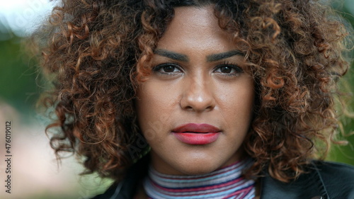 Brazilian black woman portrait close-up face looking at camera with curly hair