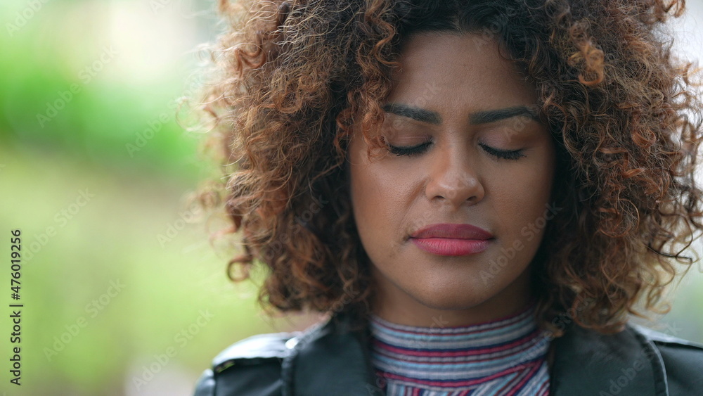 Black African woman taking a deep breath breathing outside closing eyes Black African woman taking a deep breath breathing outside closing eyes
