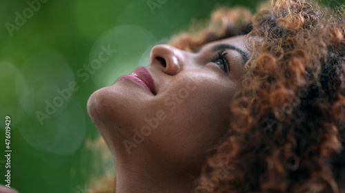 African woman looking up to sky