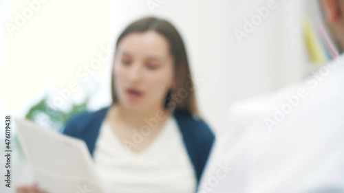 4k slow motion video of blurred cropped view of pregnant woman talking to doctor.
