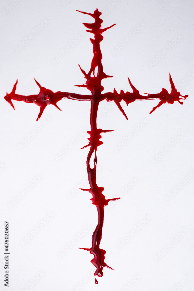 Fototapeta premium Barbwire crucifix made wit red paint resembling blood 