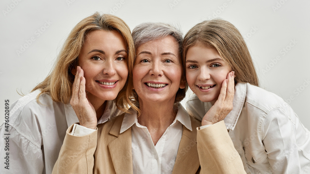 Joyful family of three females looking at camera Joyful family of three females looking at camera