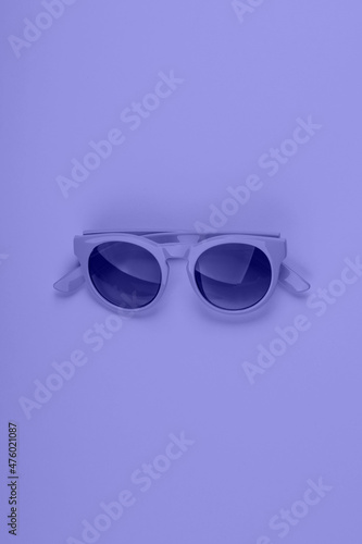 Purple very peri color sun glasses. Monochrome fashion flat lay