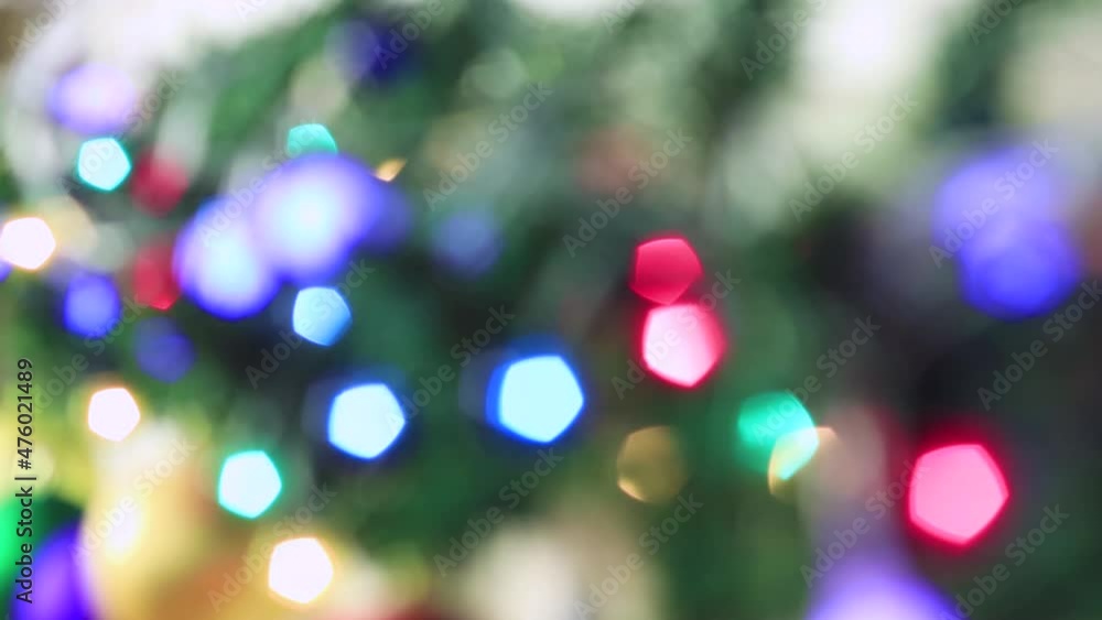 Blurred Christmas fairy colorful lights are burning brightly. New Year's light out of focus. Video, footage for screensaver, intro, presentation, transition, congratulations, effects. UHD 4K. Blurred Christmas fairy colorful lights are burning brightly. New Year's light out of focus. Video, footage for screensaver, intro, presentation, transition, congratulations, effects. UHD 4K.