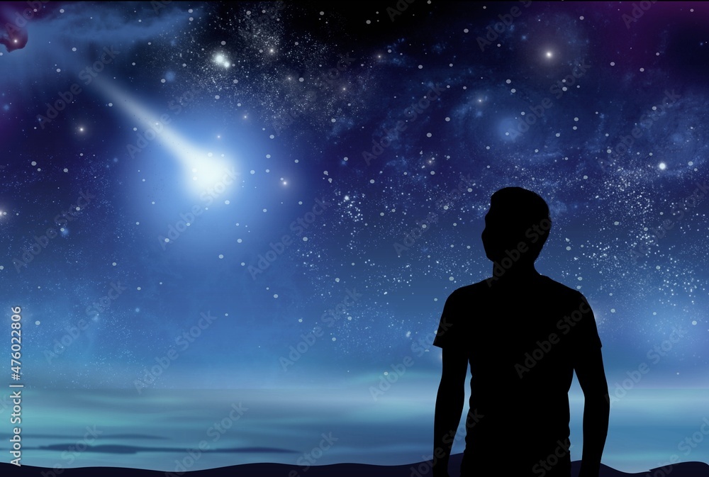 Fototapeta premium Silhouette of a young man enjoying countryside under the starry skies.