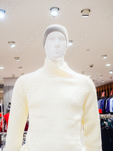 White male mannequin in gray knitted hat and milky sweater photo