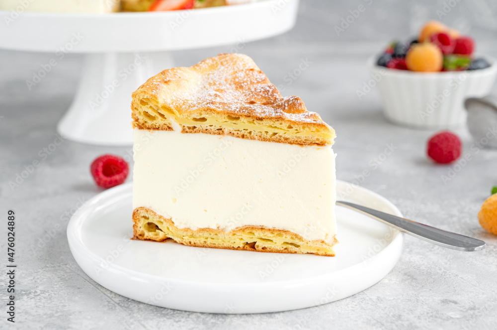 Traditional Polish cake Karpatka on a gray concrete background. Cake of