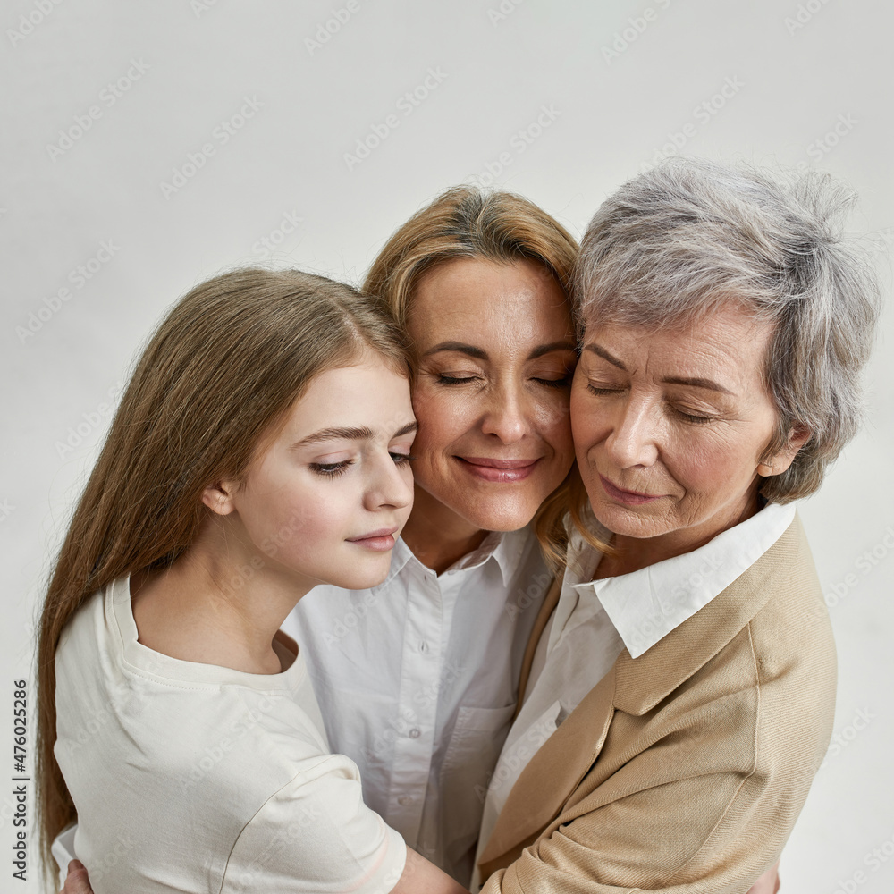 Pensive three females with closed eyes hugging Pensive three females with closed eyes hugging