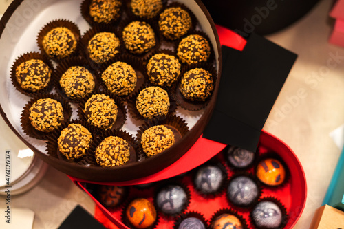 Obraz na płótnie A box of truffle chocolates with nuts on the festive table. w salonie