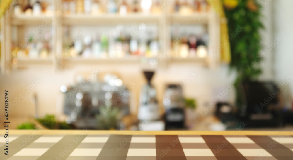 Bar and coffee shop environment blur background with coffee machine, bottle, Gin, Whisky, glass, grinder, counter bar and wooden table top.