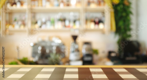 Fototapeta Naklejka Na Ścianę i Meble -  Bar and coffee shop environment blur background with coffee machine, bottle, Gin, Whisky, glass, grinder, counter bar and wooden table top.